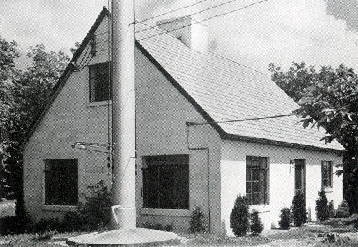 Concrete foundation of antenna mast next to building