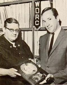WDRC music director Bertha Porter receives a gold record from Al Khoury of Capitol Records for her efforts in making Al Martino's I Love You Because a national hit (Billboard Magazine, August 3, 1963