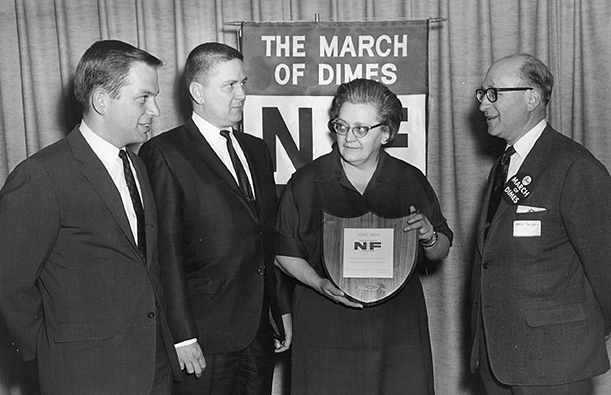 WDRC's Charlie Parker and Bertha Porter receive an award from unidentified March of Dimes officials